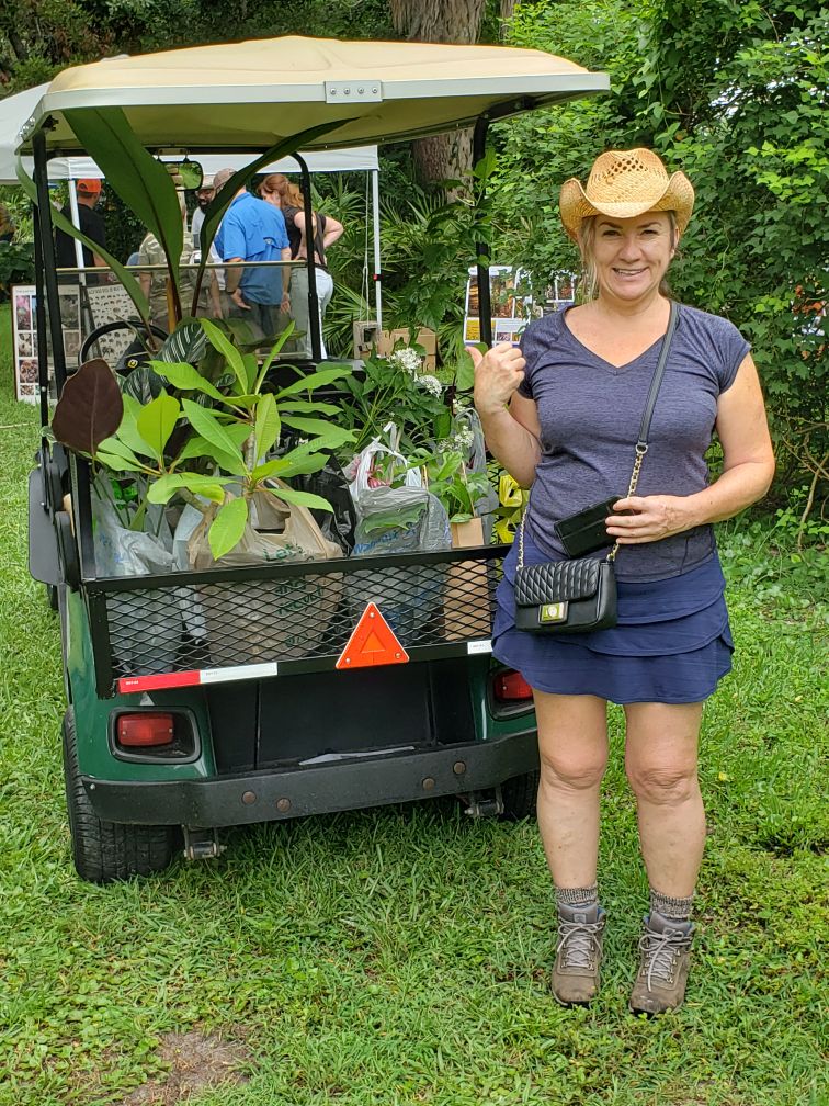 me with the back of the golf cart full of plants from the USF Botanical Garden sale